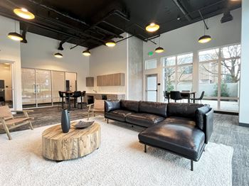 A living room with a leather couch and a coffee table